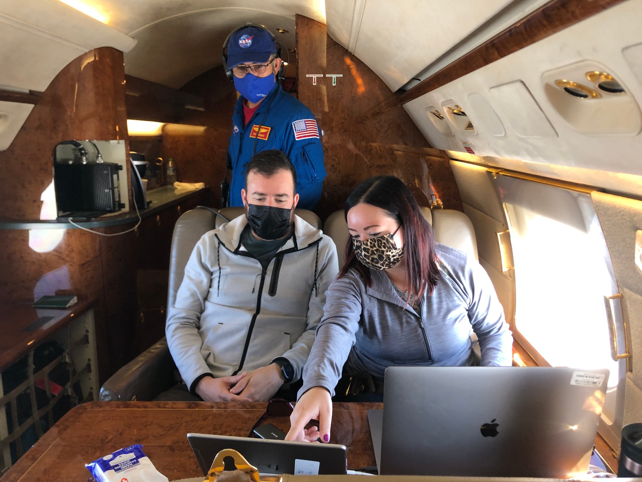 Flight safety officer Tony Henriquez, in blue, in the Gulfstream V's cabin with Langley's Taylor Shingler and TRACER-AQ Co-PI Laura Judd. 