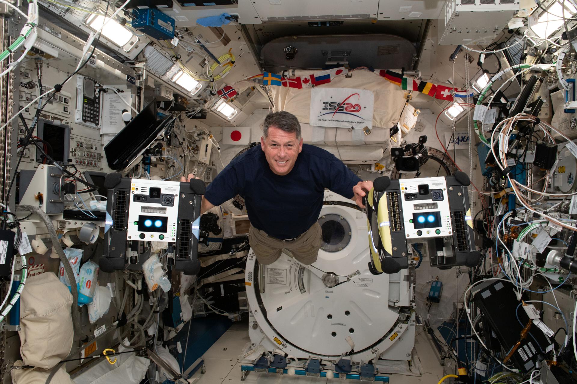 NASA astronaut and Expedition 65 Flight Engineer Shane Kimbrough inside the Kibo laboratory module with the Astrobee free-flying robotic assistants May 3. 