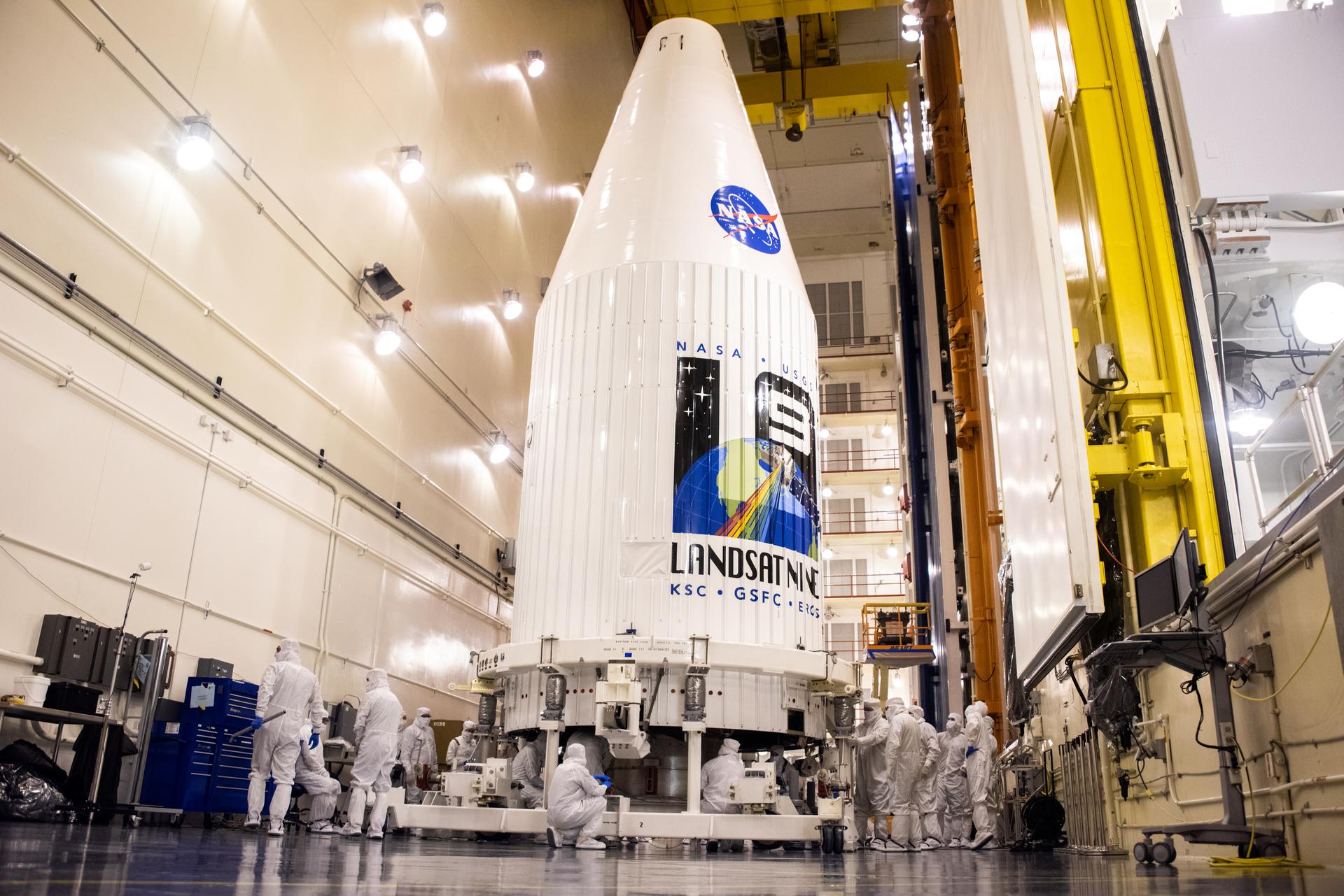 Inside the Integrated Processing Facility at Vandenberg Space Force Base in California, both United Launch Alliance (ULA) payload fairings are secured around the Landsat 9 spacecraft on Aug. 16, 2021.