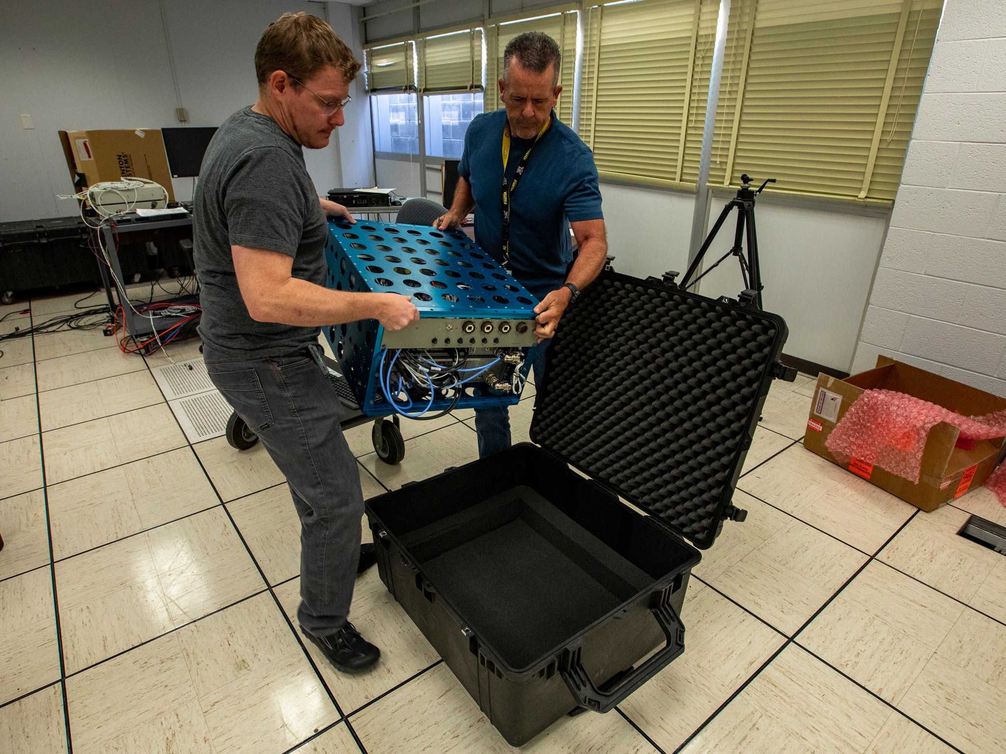 NASA researchers load the XVS into a shipping crate