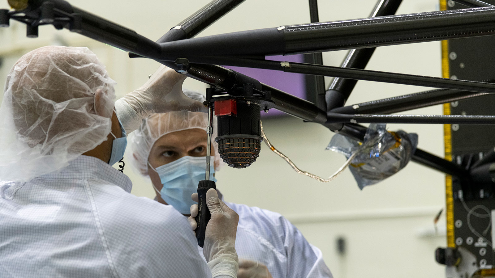 Engineers at NASA’s Jet Propulsion Laboratory in Southern California integrate the magnetometer instrument into the agency’s Psyche spacecraft on June 28, 2021.