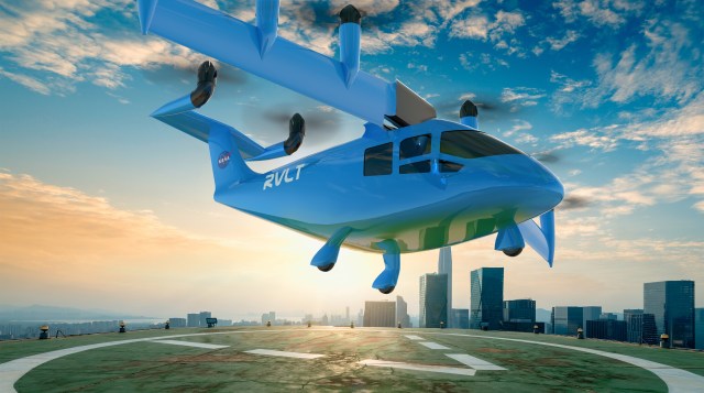 Artist concept of a vertical lift vehicle at a vertiport at sunset.