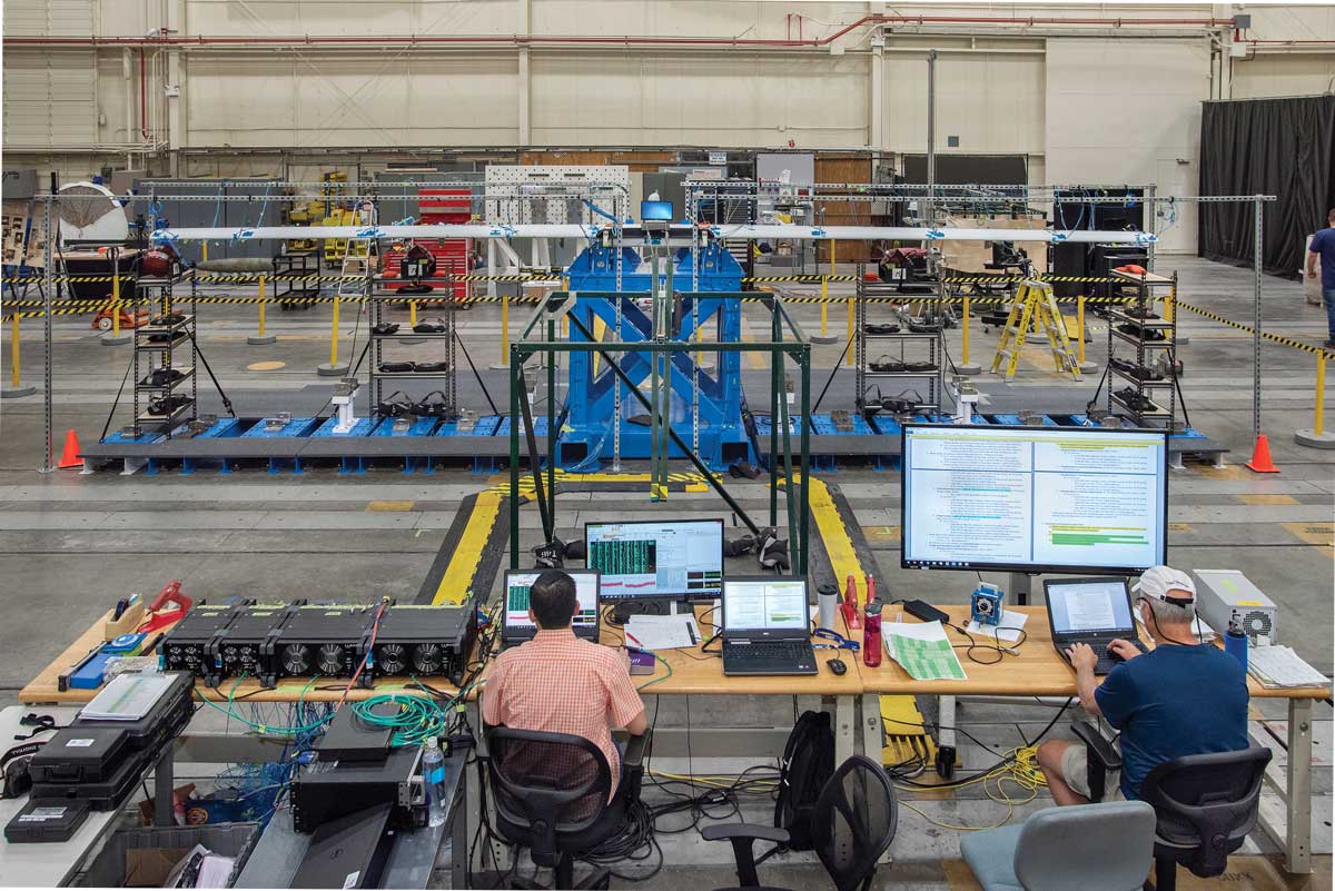 Technicians at computers conducting testing.