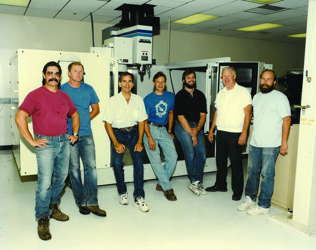 Men standing in front of a machine