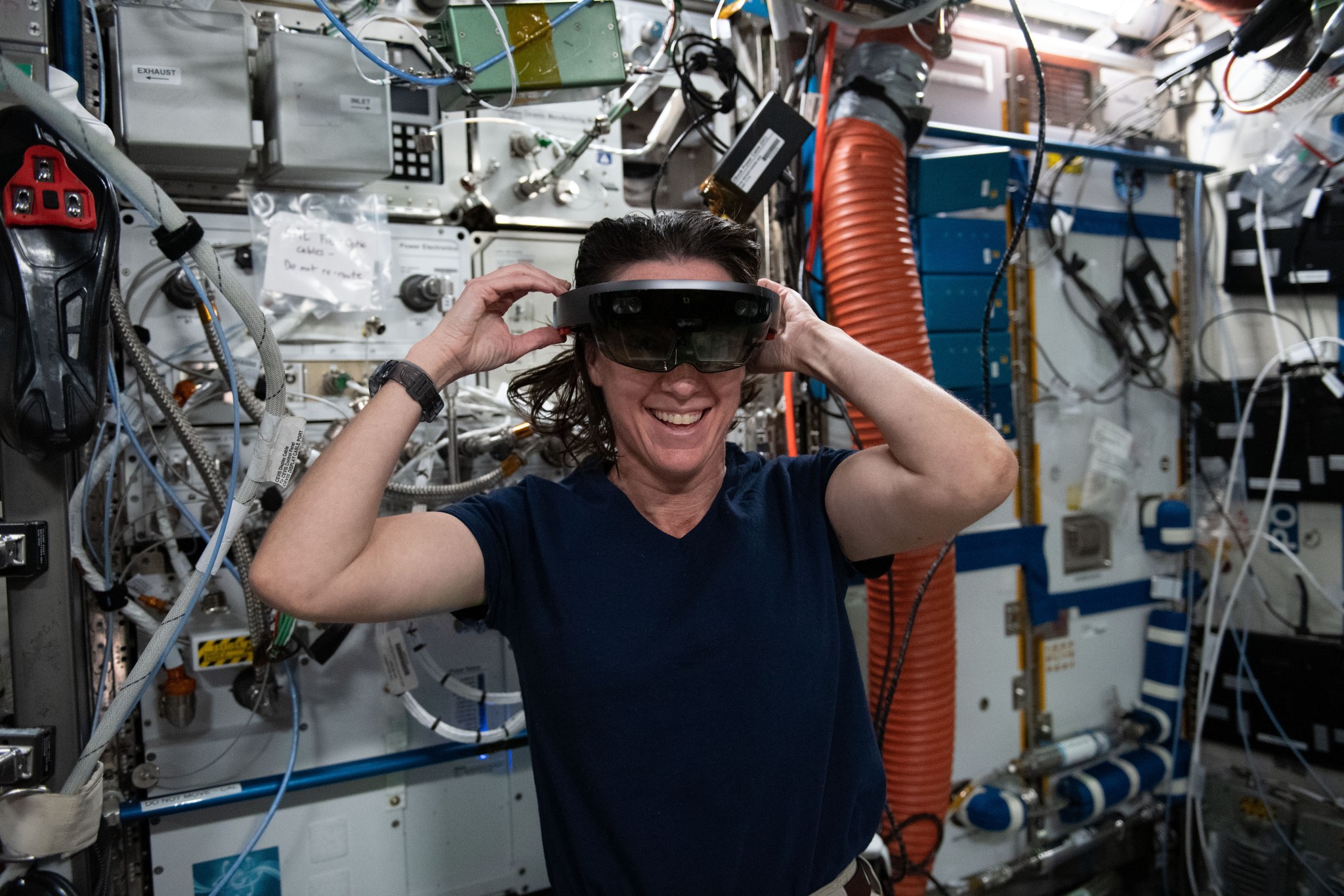 NASA Astronaut Megan McArthur dons a Microsoft HoloLens, a mixed reality (or augmented reality) headset, which allows her to see both the spacearound her as well as digital displays in her field of view.