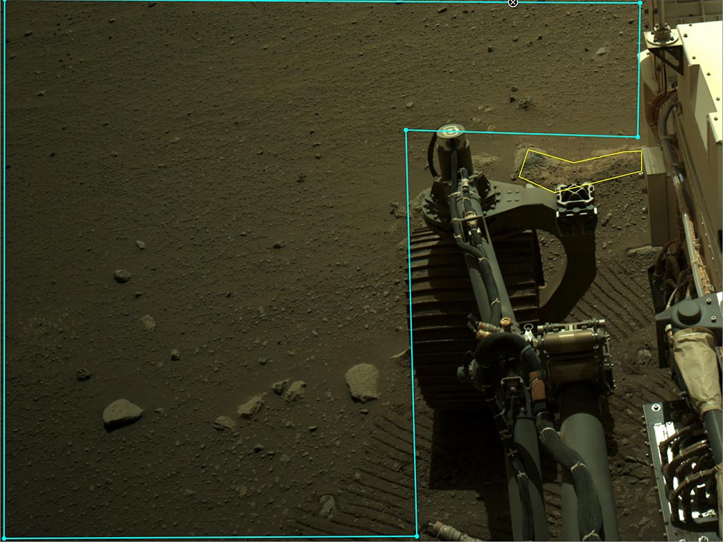 Parts of Perseverance are visible beside an area outlined in AI4Mars