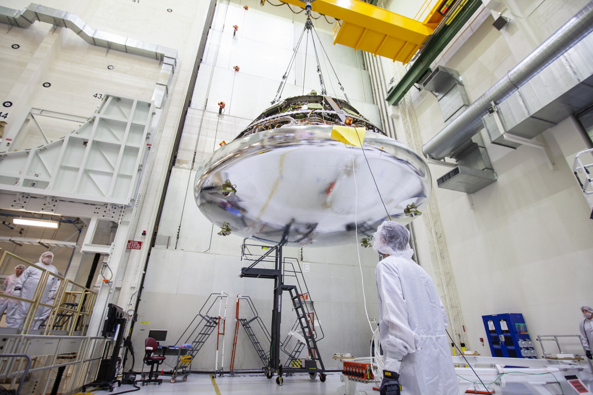 The Orion crew module for Artemis 1 is lifted by crane on July 16, 2019, in the high bay inside the Neil Armstrong Operations and Checkout Building.