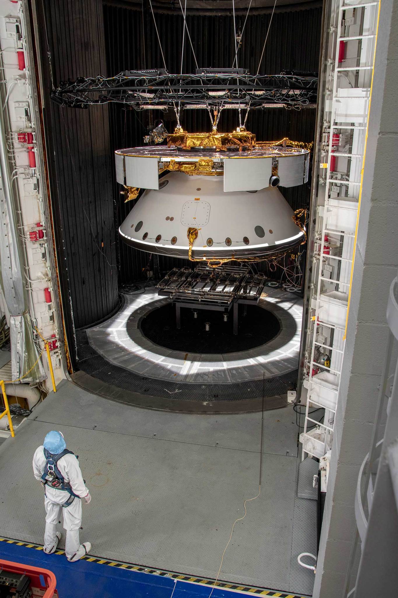 A man looks into the 25-foot Space Simulator where the Mars 2020 spacecraft is being tested.