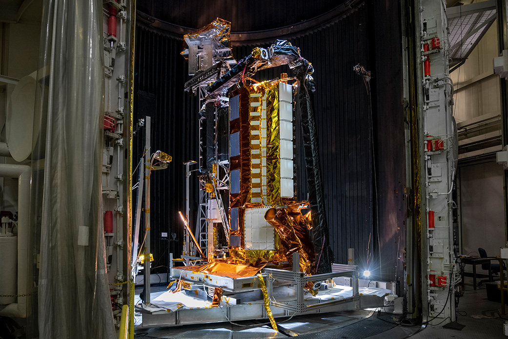 Part of the NISAR satellite rests in a thermal vacuum chamber 