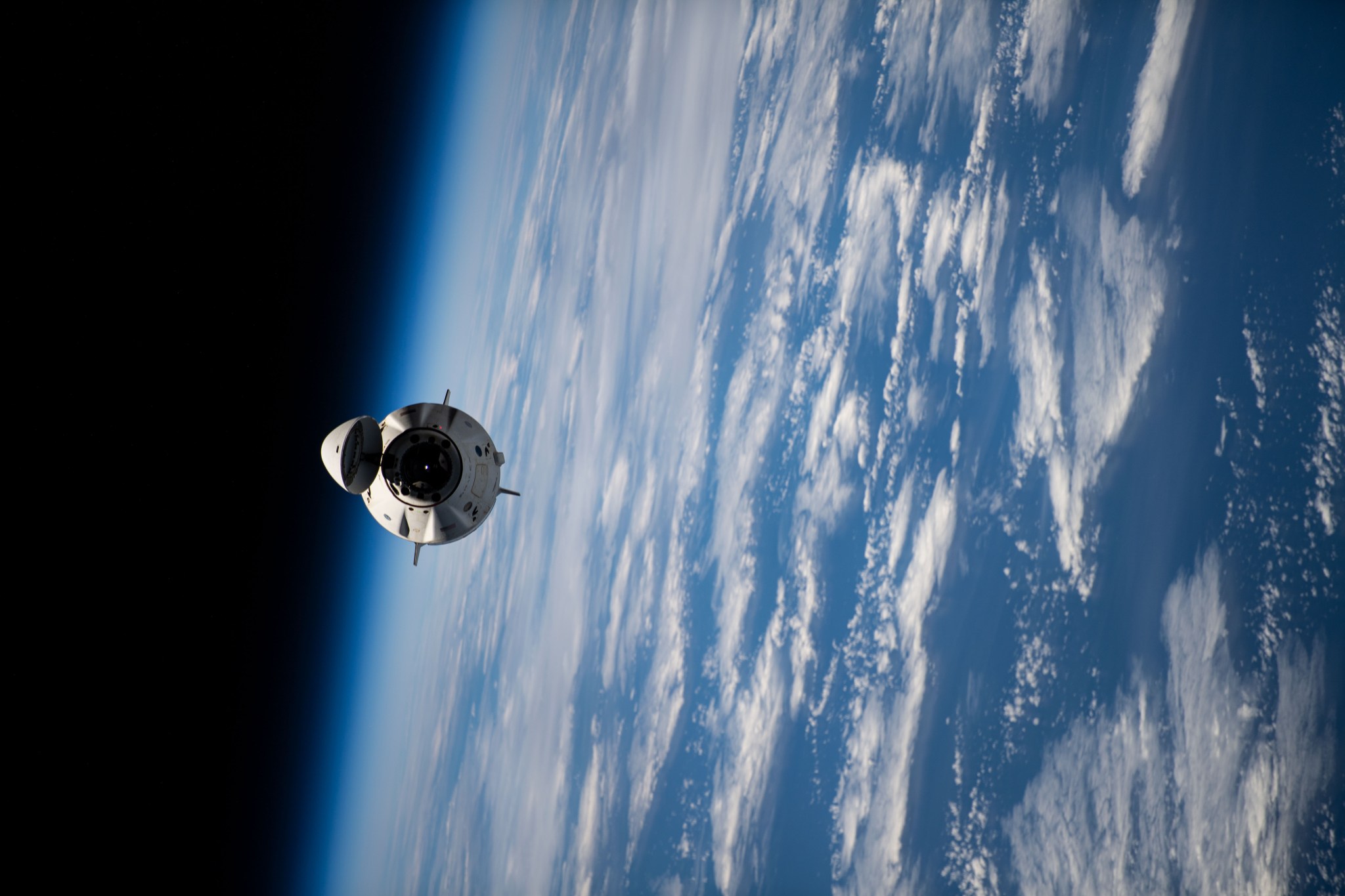 image of a capsule with Earth in backdrop