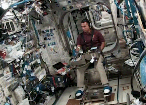 image of astronaut working with an experiment