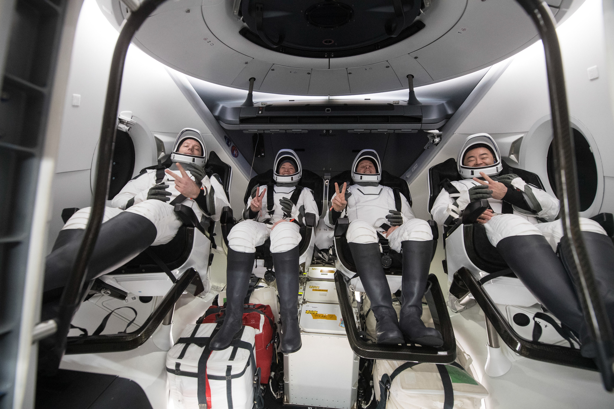ESA (European Space Agency) astronaut Thomas Pesquet, left, NASA astronauts Megan McArthur and Shane Kimbrough, and Japan Aerospace Exploration Agency (JAXA) astronaut Aki Hoshide, right, are seen inside the SpaceX Crew Dragon Endeavour spacecraft.