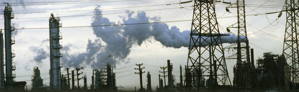 Photo of a factory smokestack in New Jersey emitting pollutants into the atmosphere.