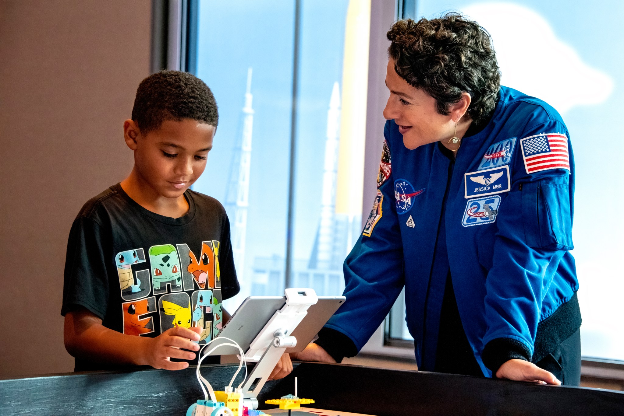 NASA Astronaut Jessica Meir interacts with student during a LEGO Education Build to Launch event held at the Kennedy Space Center Visitors Center in the days leading up to the first Artemis I launch attempt in August 2022.