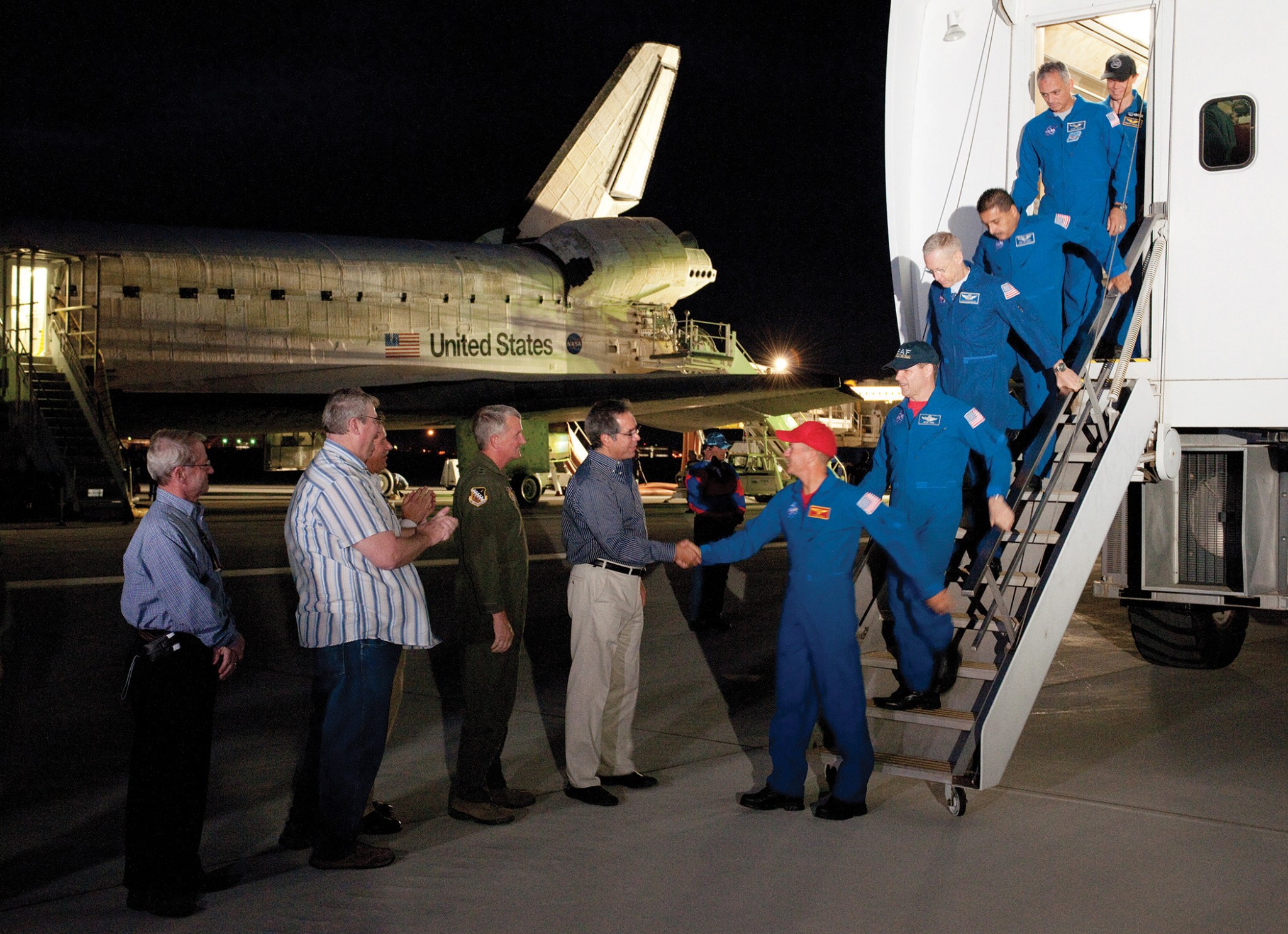 Space shuttle Discovery crew exiting an aircraft.