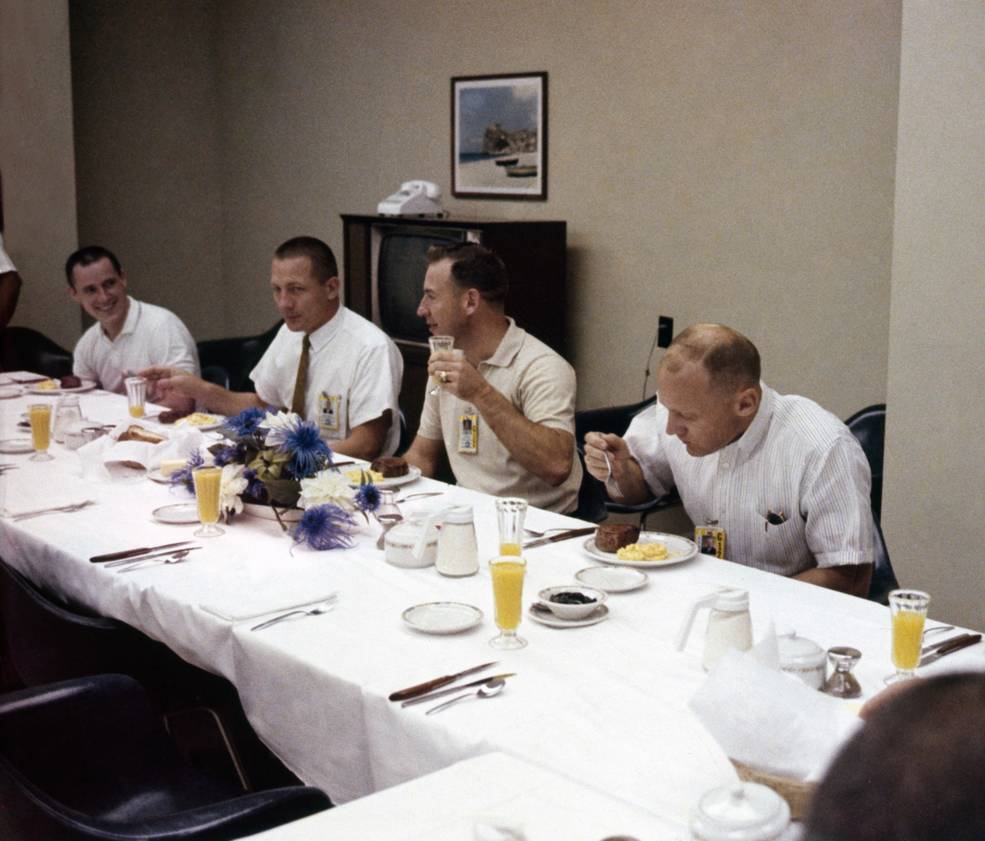 Support astronauts Edward G. Gibson, left, and John L. “Jack” Swigert join Gemini XII astronauts Lovell and Aldrin for the traditional prelaunch breakfast.