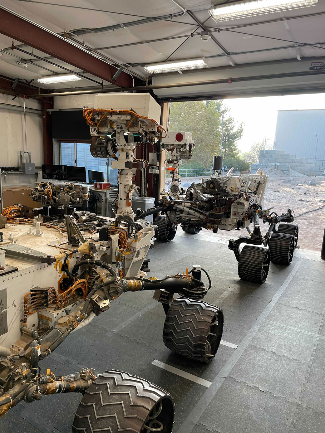 Engineering models of the Curiosity Mars rover (foreground) and the Perseverance Mars rover 