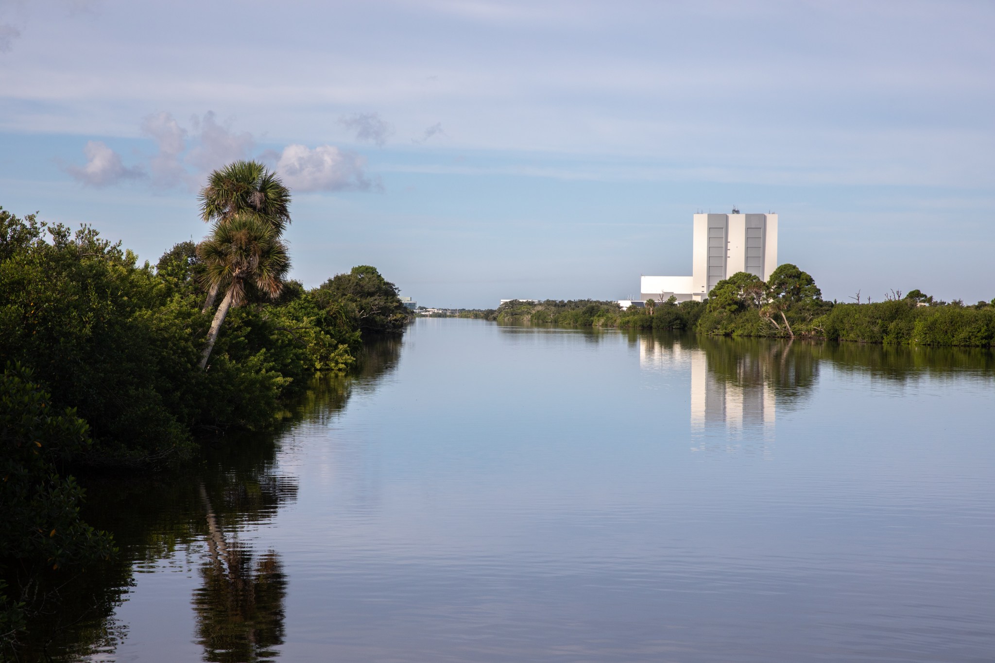 Kennedy Space Center's Vehicle Assembly Building in the background of the Indian River Lagoon estuary.