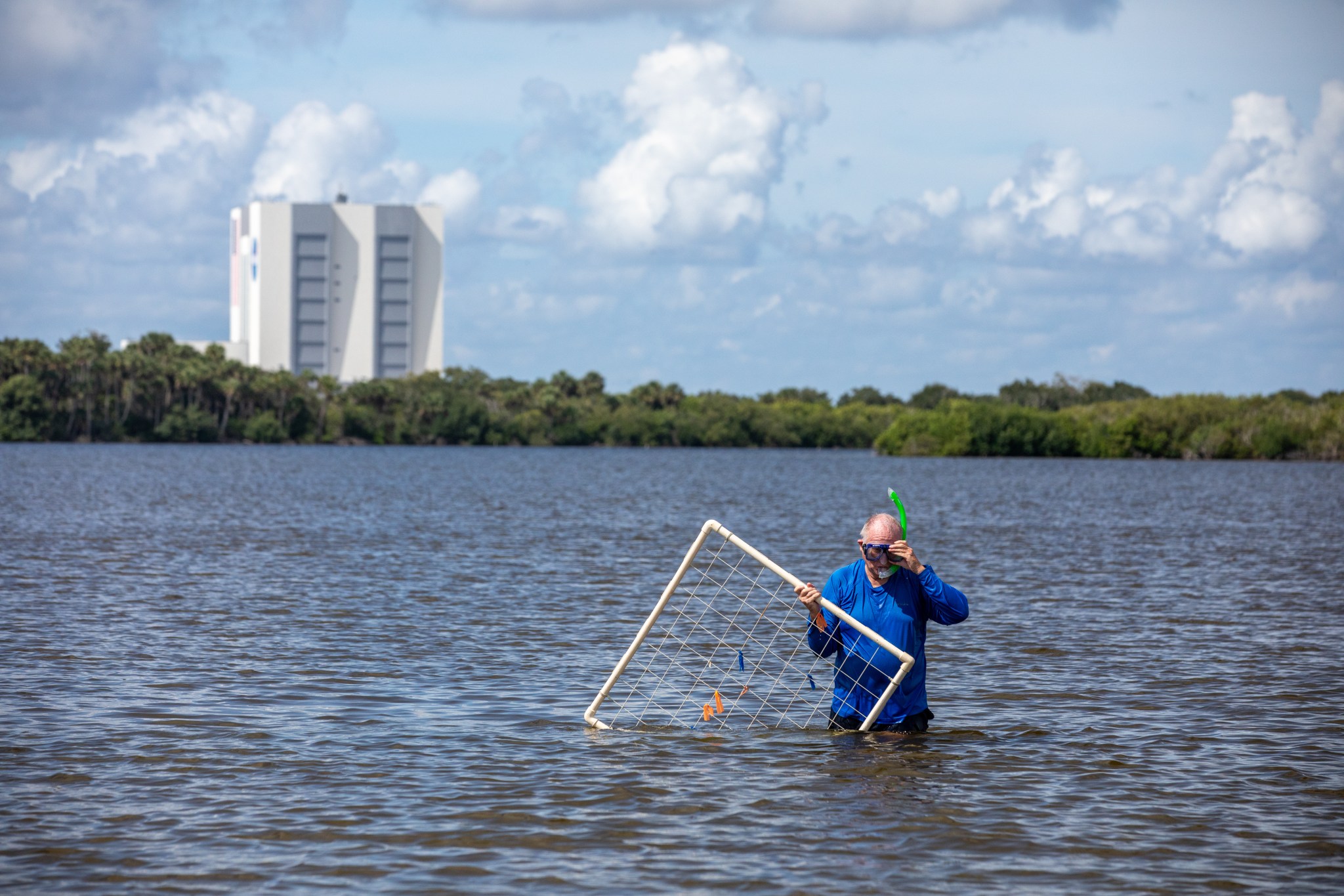 NASA's Doug Scheidt measures seagrass density at Pepper Flats, just south of the visitors gantry.