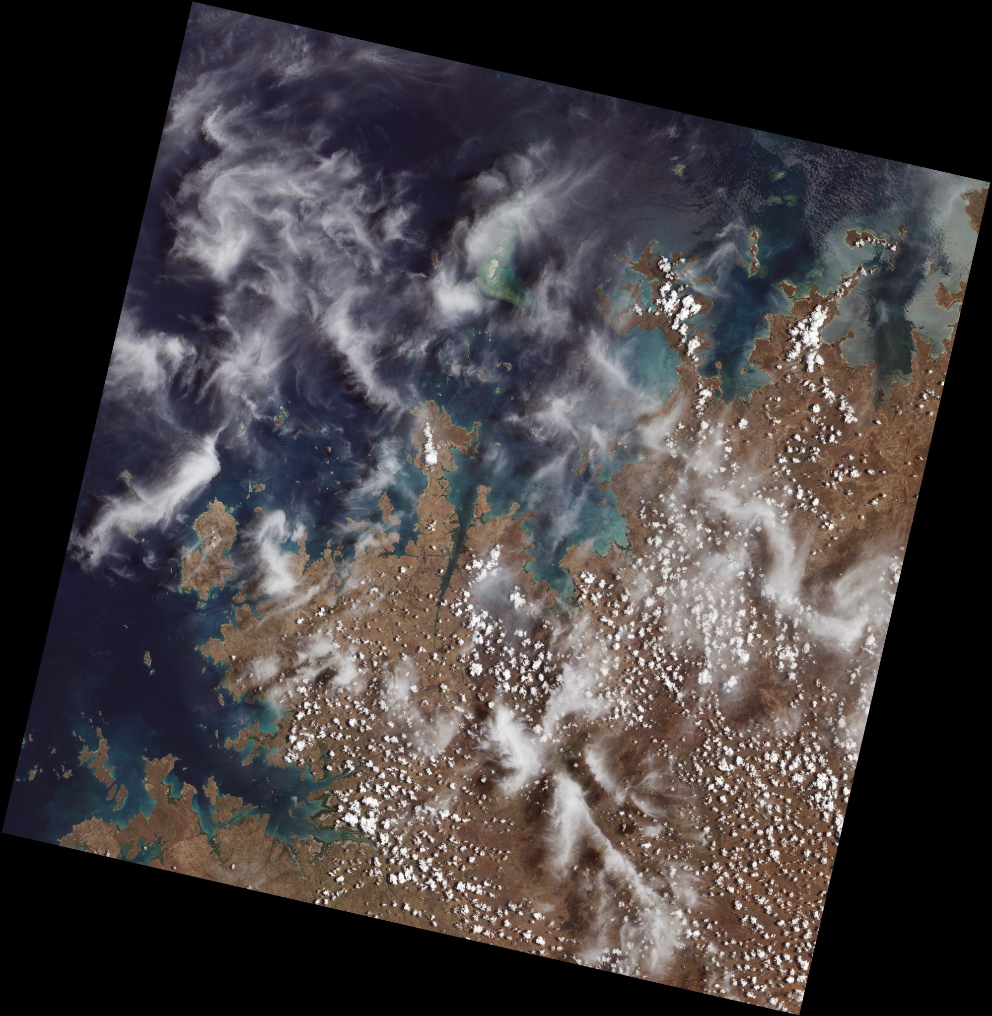 The first image collected by Landsat 9, on Oct. 31, 2021, shows mangroves along the northwest coast of Australia clustered in protected inlets and bays on the edge of the Indian Ocean. Fluffy cumulus clouds and high-altitude cirrus clouds hover nearby. 