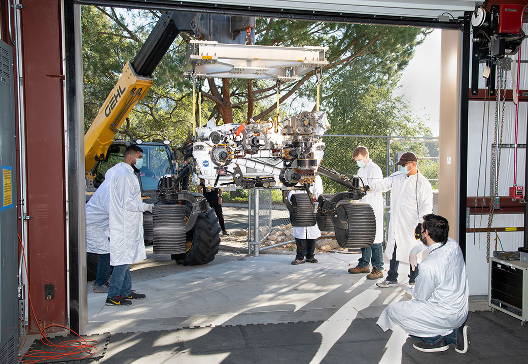 A heavy-duty vehicle transports the Perseverance rover’s engineering model