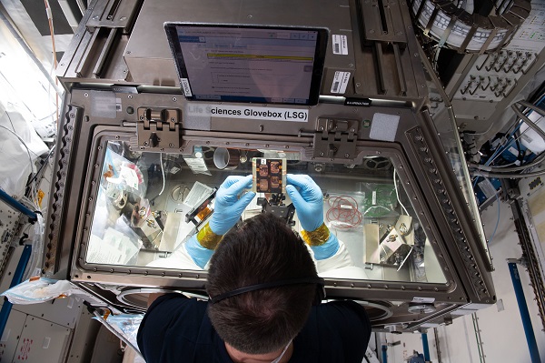 image of an astronaut working with an experiment