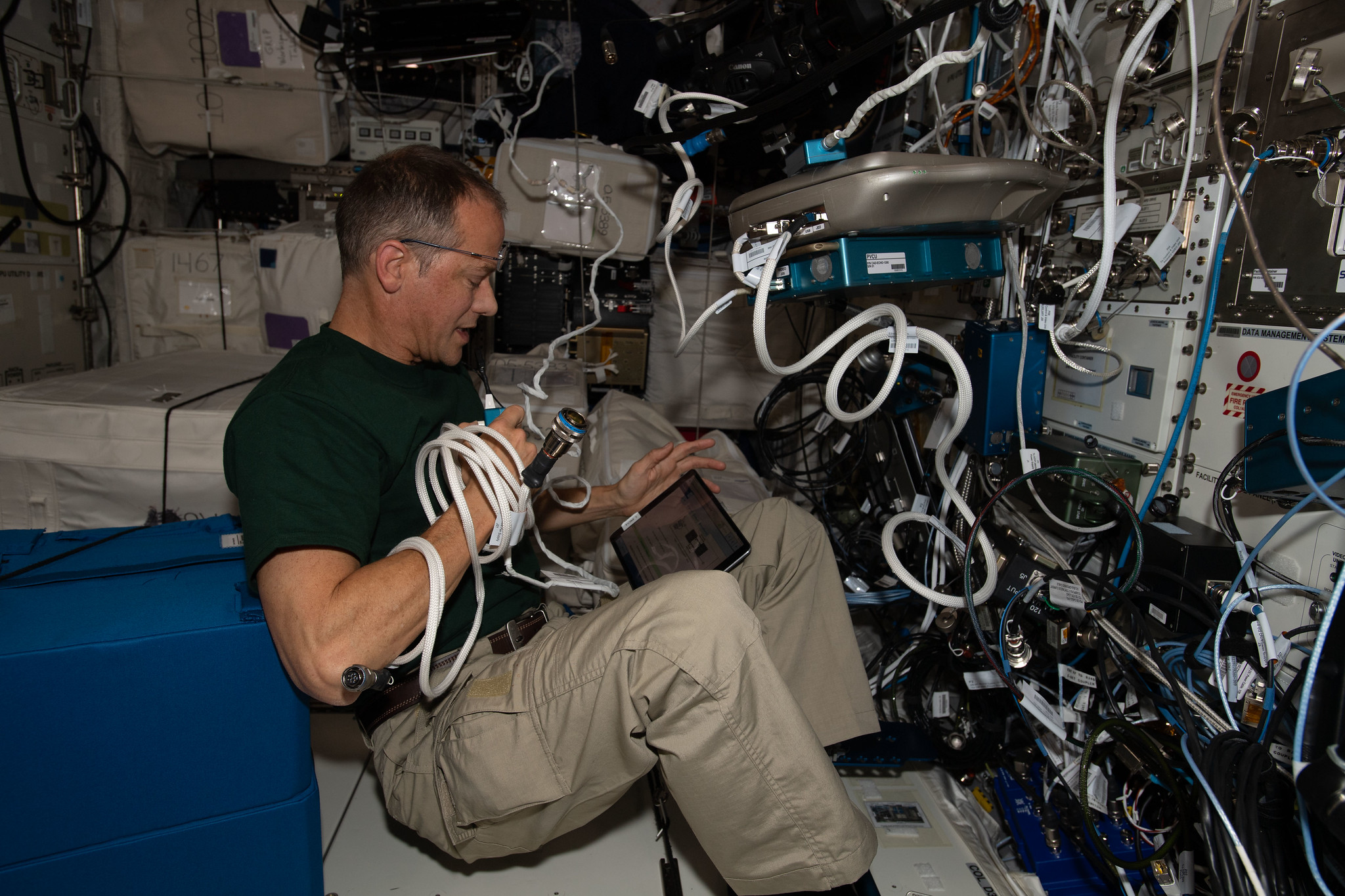 image of astronaut working with and experiment