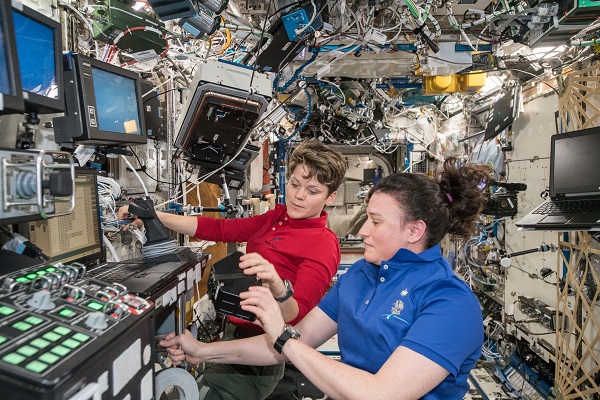 image of two astronauts working on an experiment