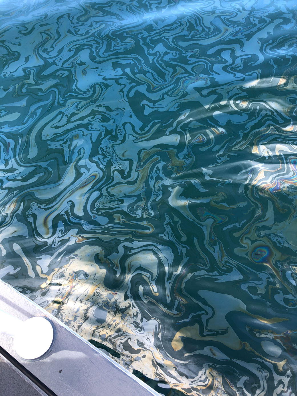 An oil slick on the surface of ocean water