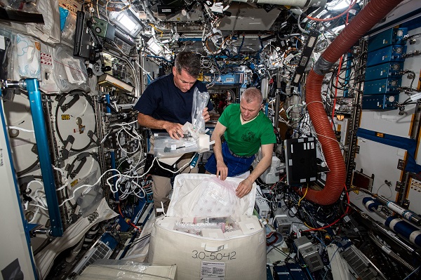 image of astronauts packing an experiment