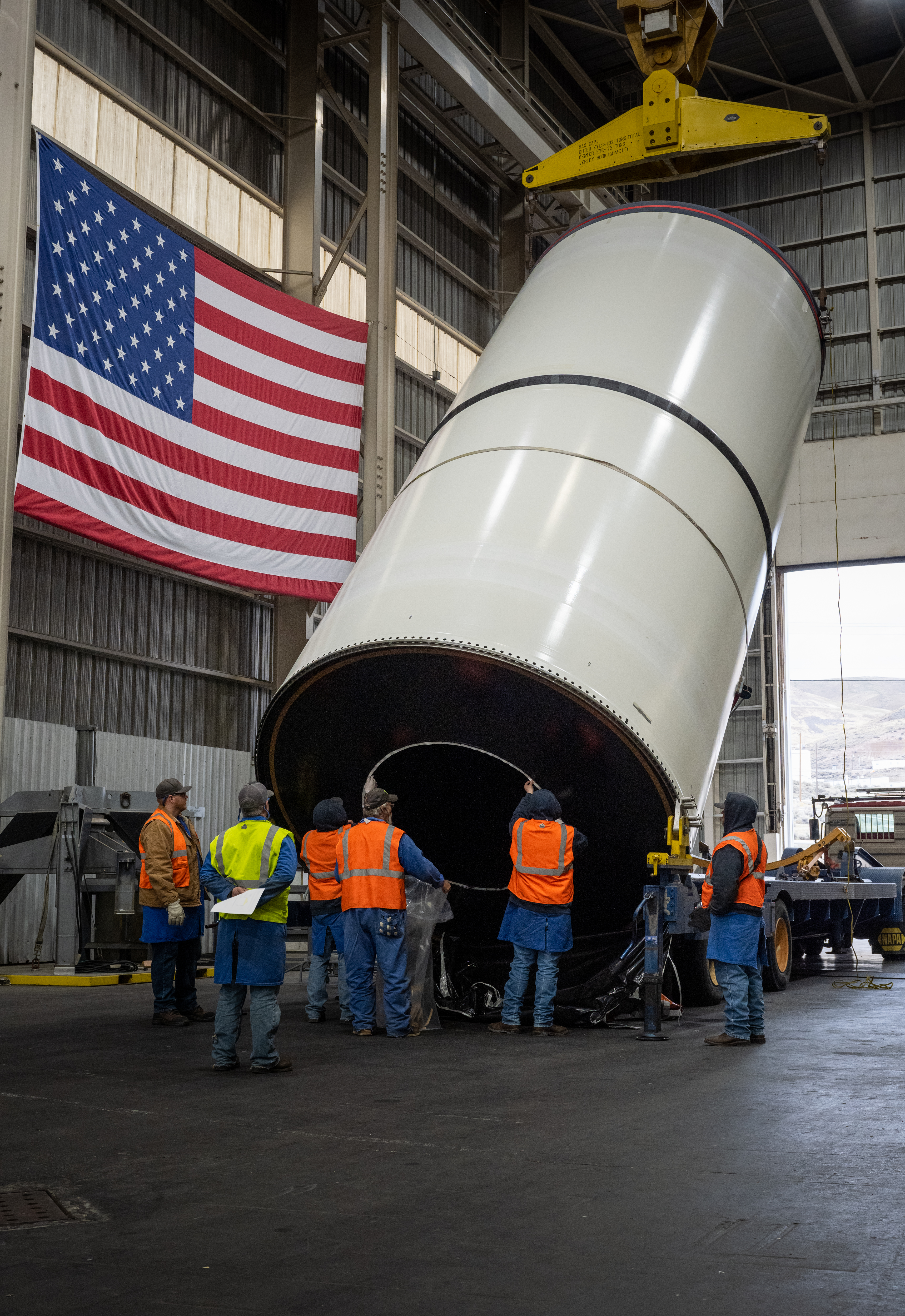 Technicians at Northrop Grumman’s factory in Promontory, Utah, lift one of the first booster motors cast for the Artemis IV mission. 