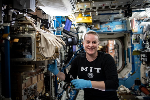 image of an astronaut working with hardware 