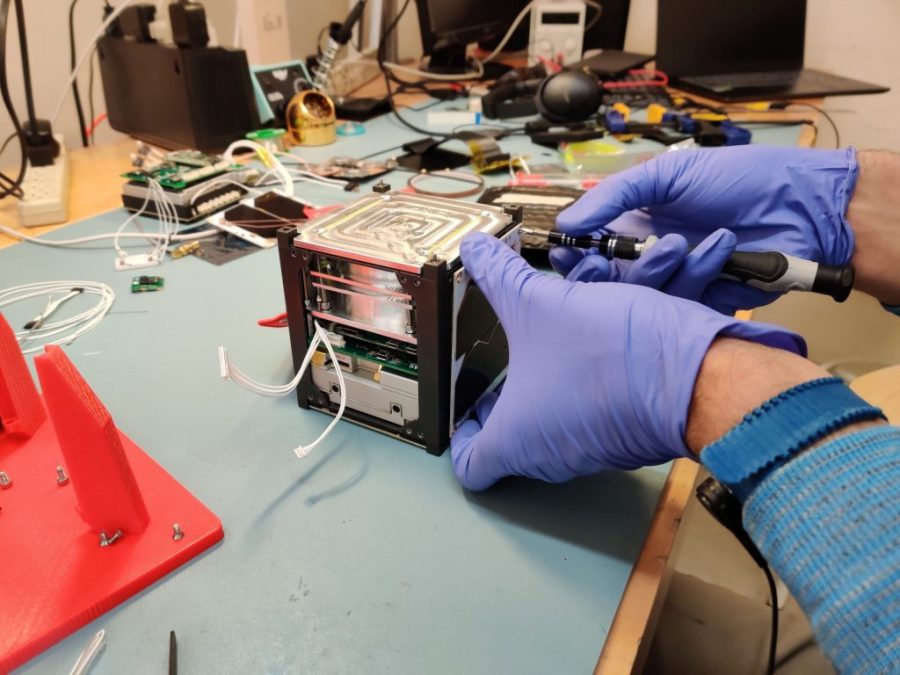 One of the solar panels being installed onto the GASPACS CubeSat during final assembly.