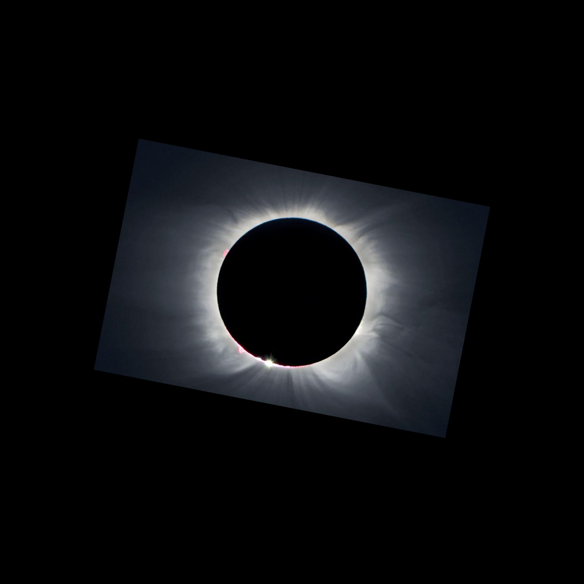 An image of a total solar eclipse shows the obscured Sun as a black disk surrounded by white streamers and other features in the solar corona, set against a black sky.