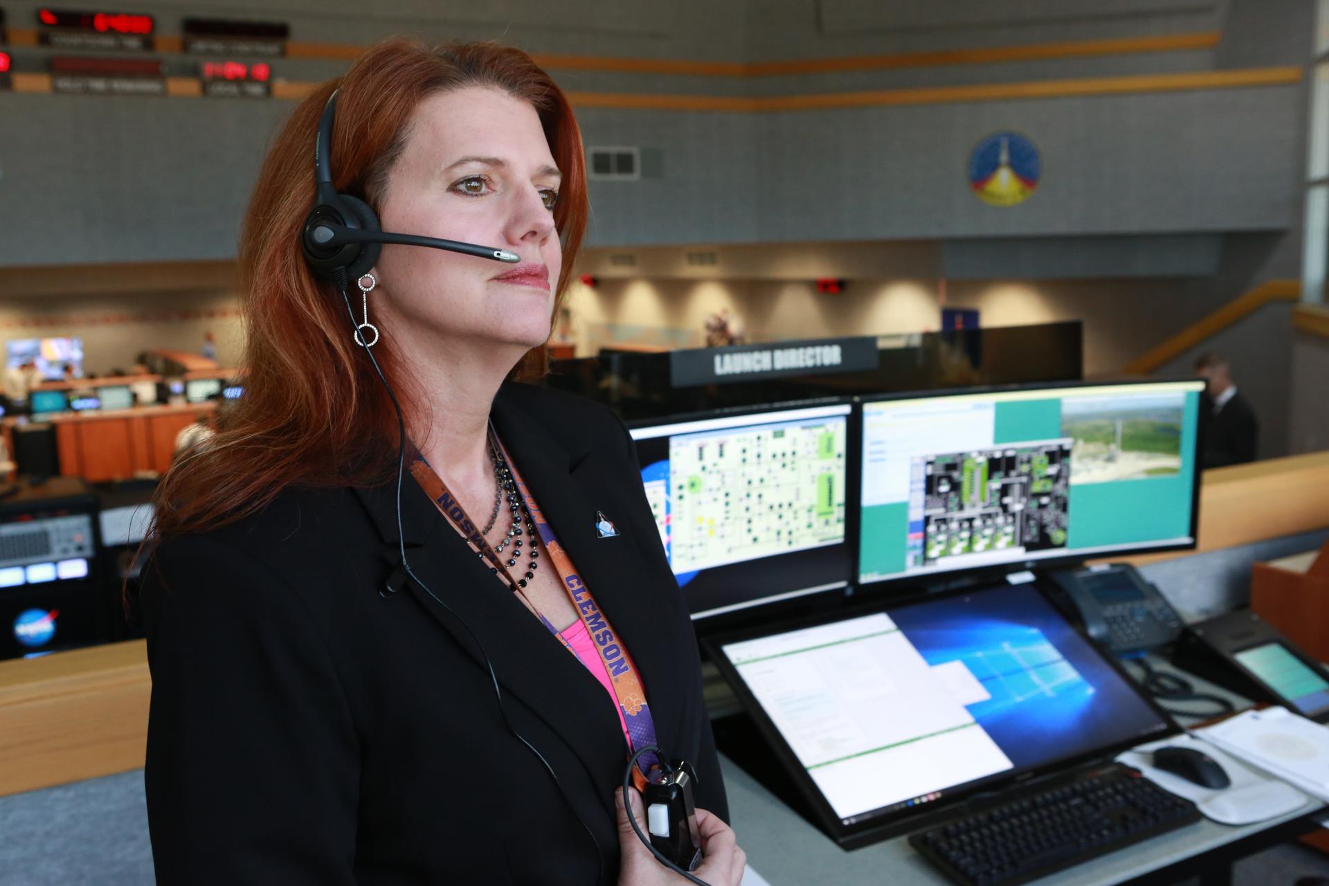 NASA Launch Director Charlie Blackwell-Thompson stands next to her console in Firing Room 1 at Kennedy Space Center’s Launch Control Center during a countdown simulation.