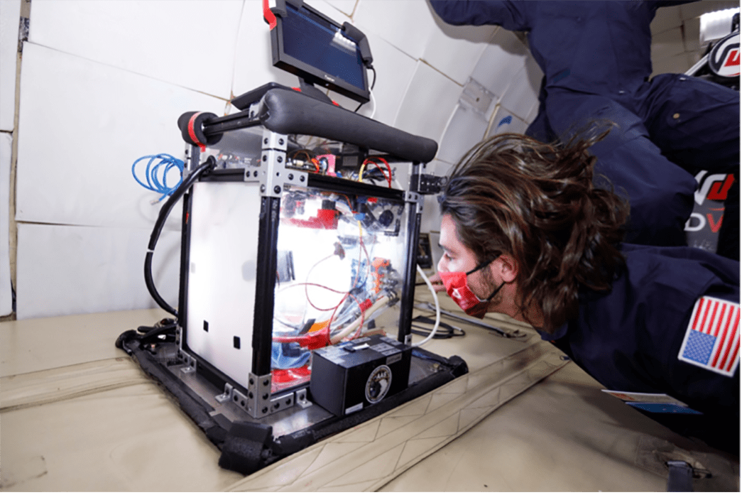 Carthage College student Nicolas Welker prepares to start a zero-gravity transfer of propellant simulant.