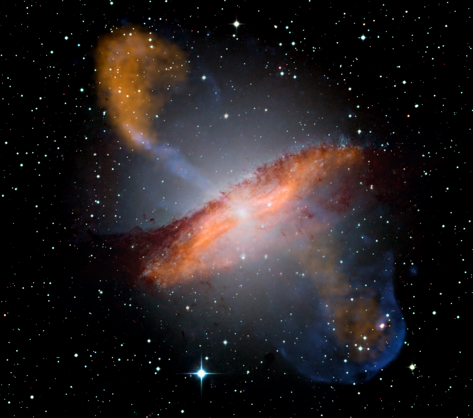 Colour composite image of Centaurus A, revealing the lobes in red and orange and jets emanating from the active galaxy’s center.