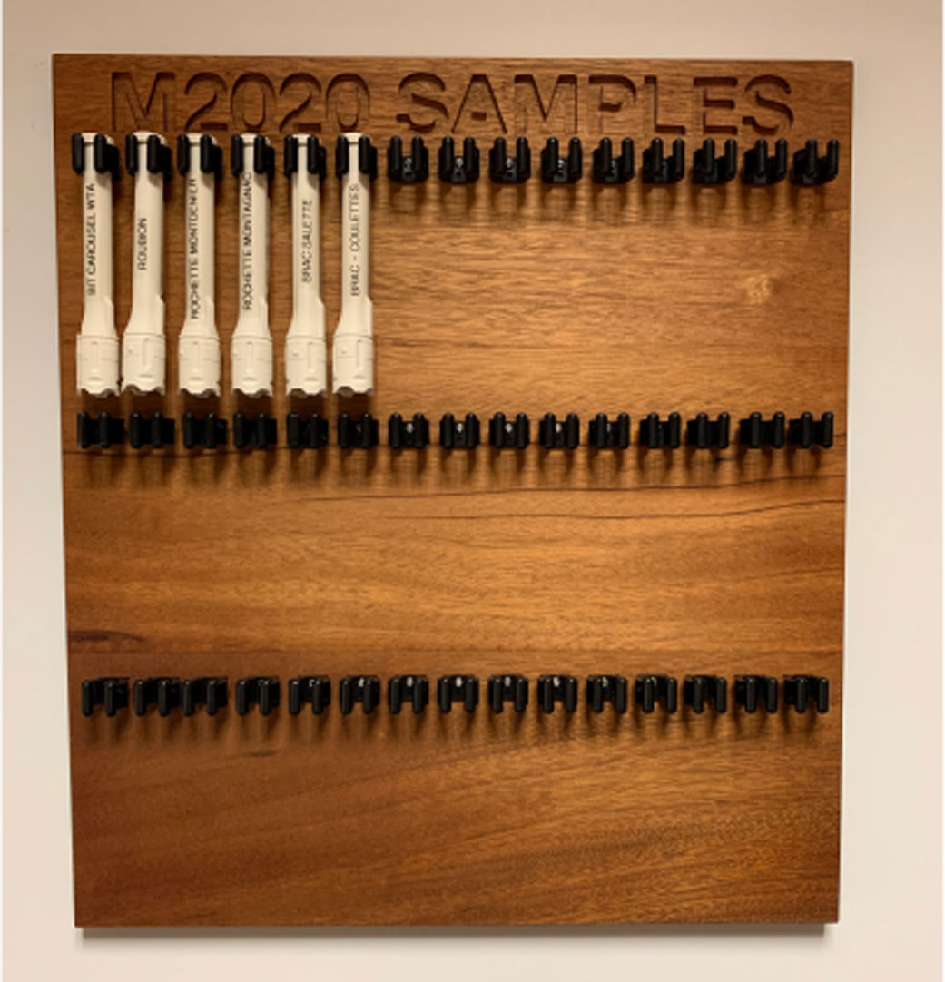 Six facsimile sample tubes hang on the sample tube board