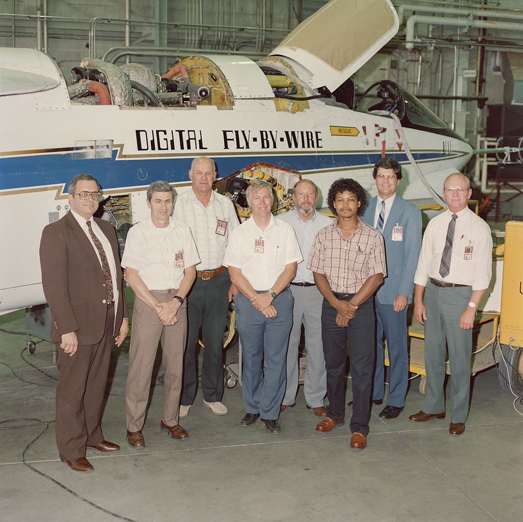 People Standing in front of an aircraft.