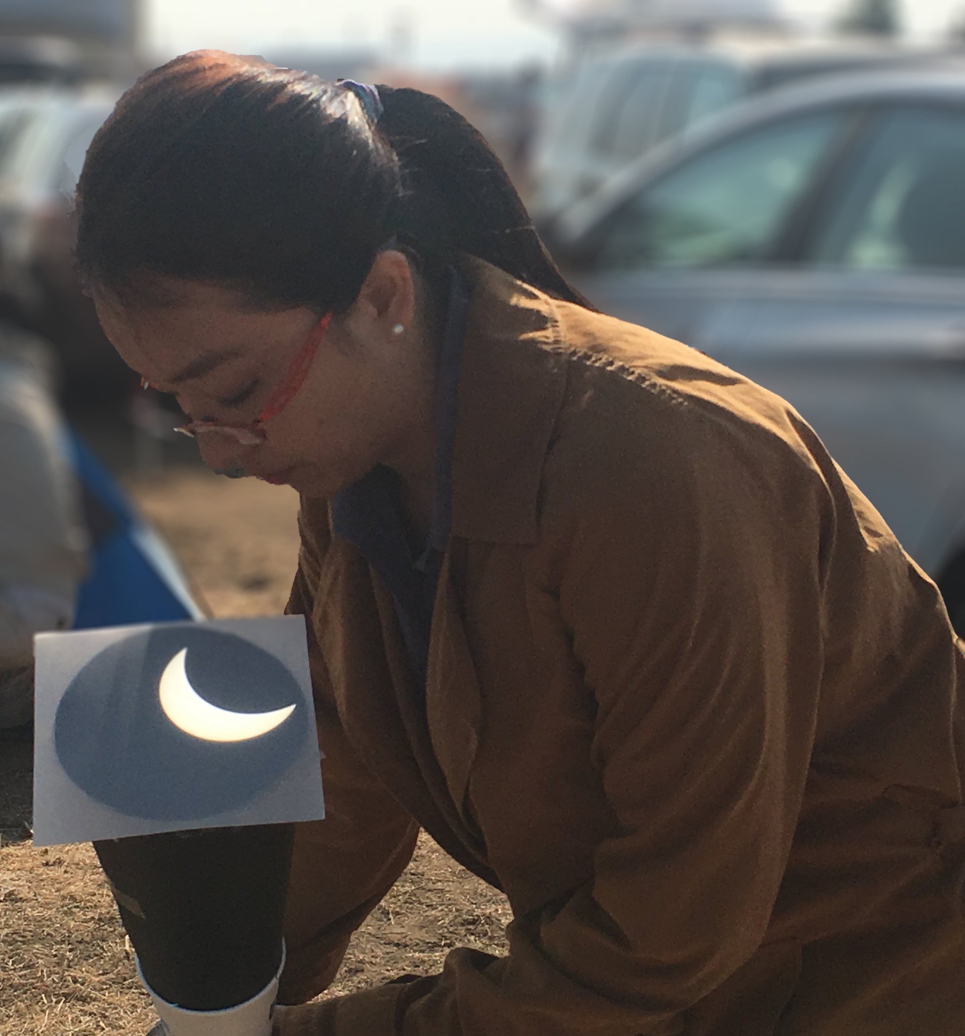 Ruizhu Chen is outside and looking down at a bright crescent.