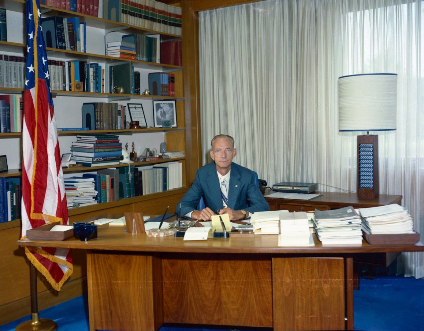 Center Director Bruce Lundin sits behind his desk in the administration building in 1977.