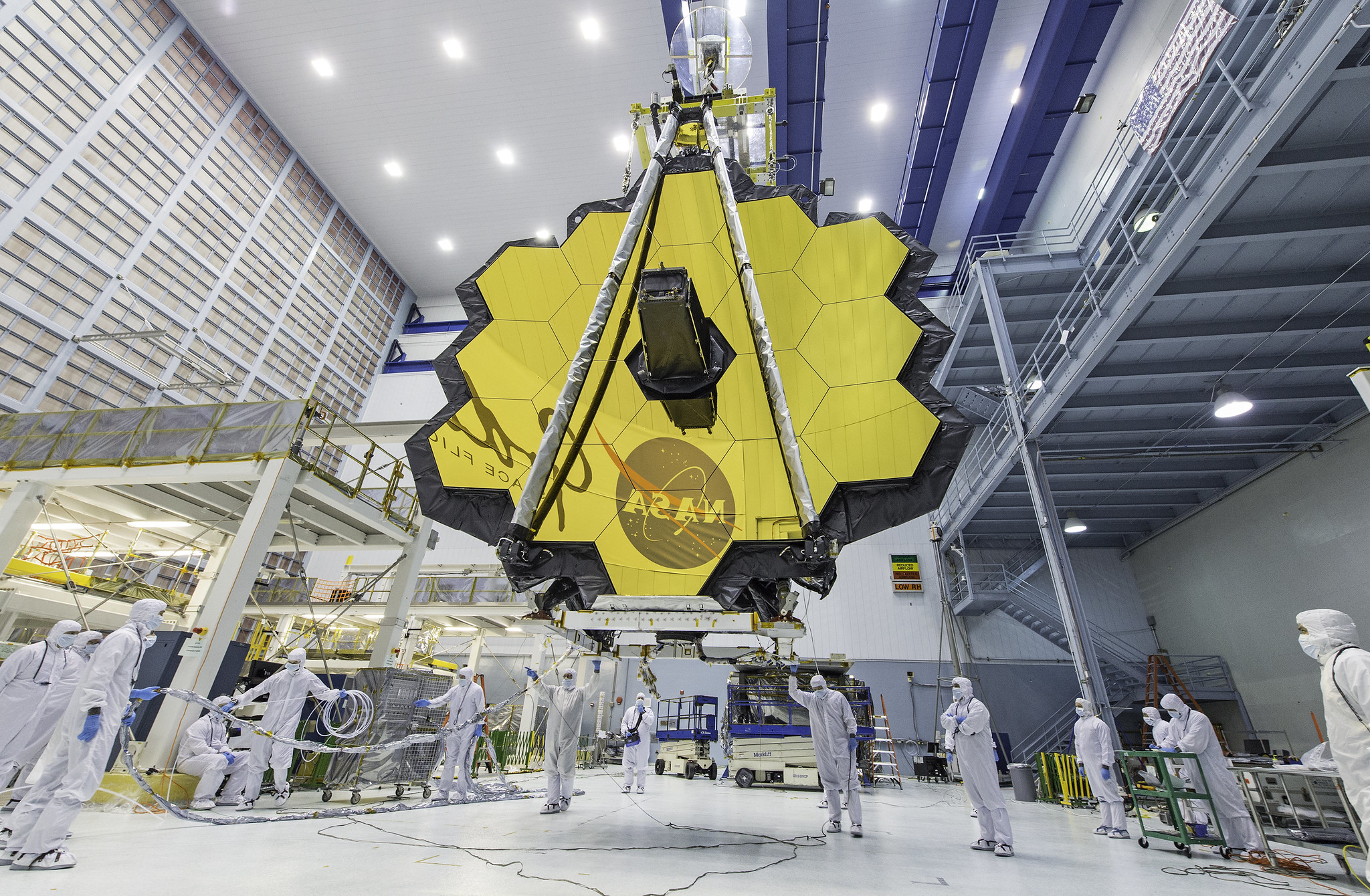 NASA technicians lift the James Webb Telescope