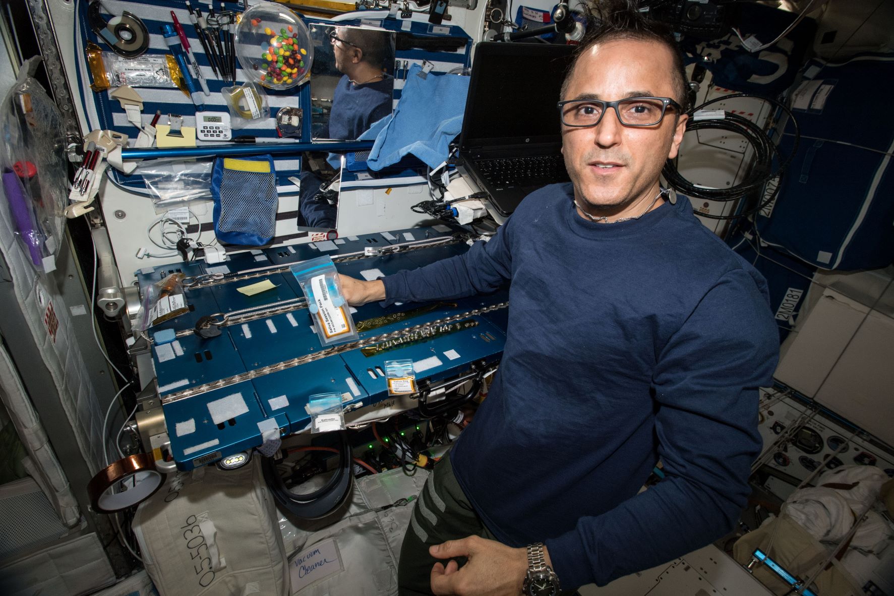NASA astronaut Joe Acaba stores a vial of saliva on the space station. His and other saliva samples are sent back to Earth, where scientists analyze them to track changes in the immune system of crews during spaceflight.