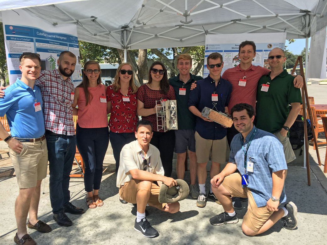 Group photo with James Smith (front left), Thomas DiSarro (front right) and Northeastern students