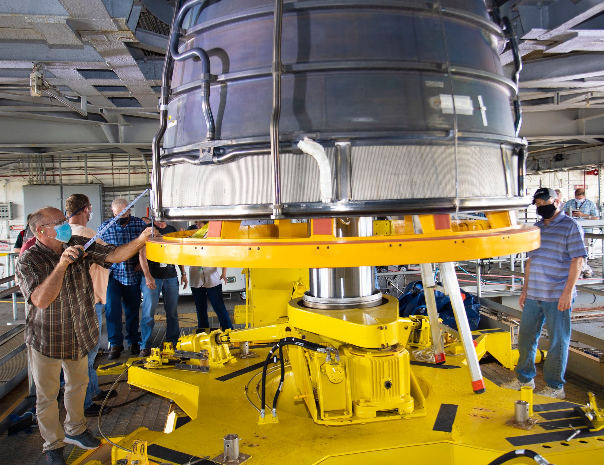 Technicians on the engine deck of the Fred Haise Test Stand