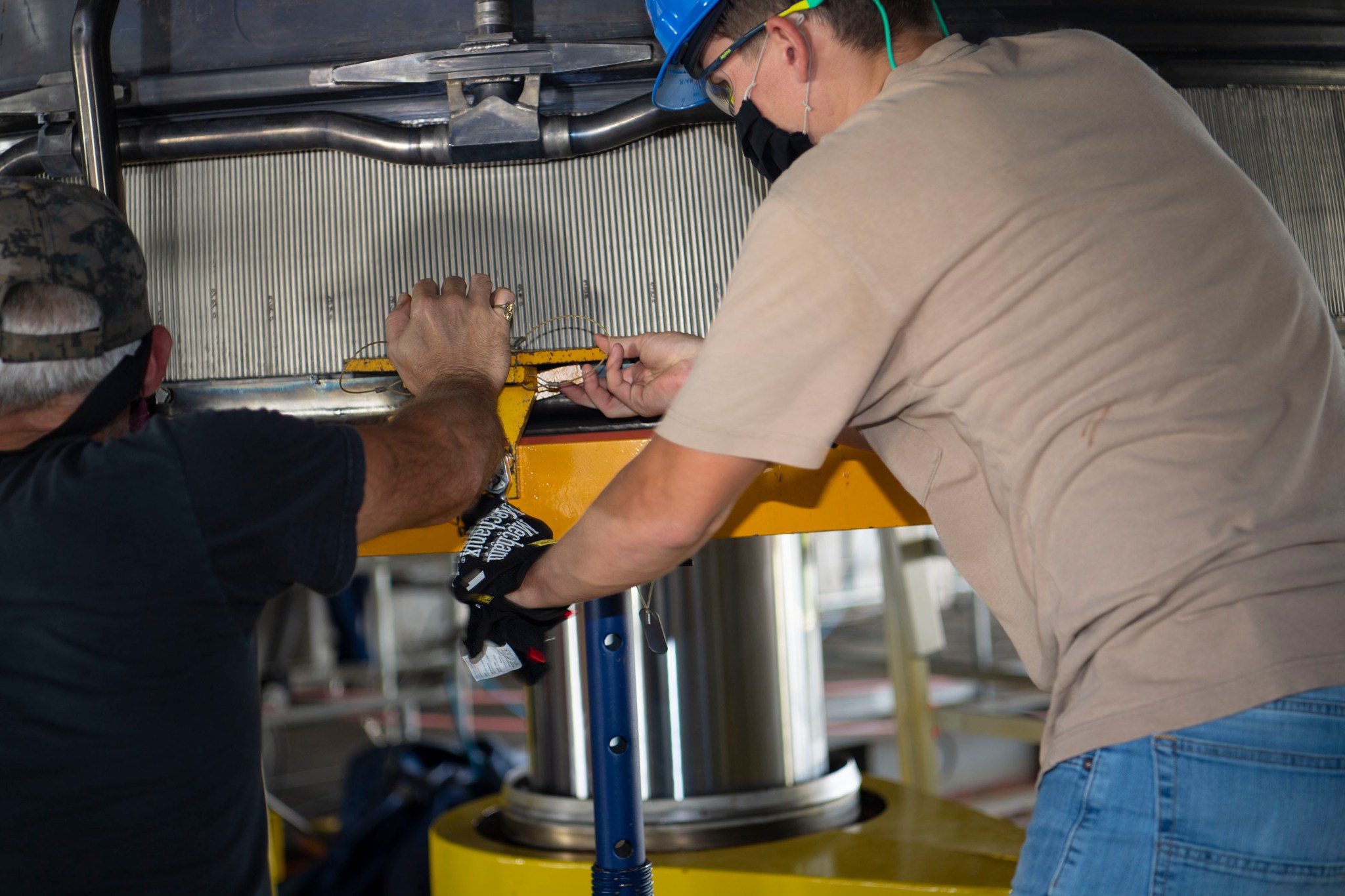 Technicians on the engine deck of the Fred Haise Test Stand