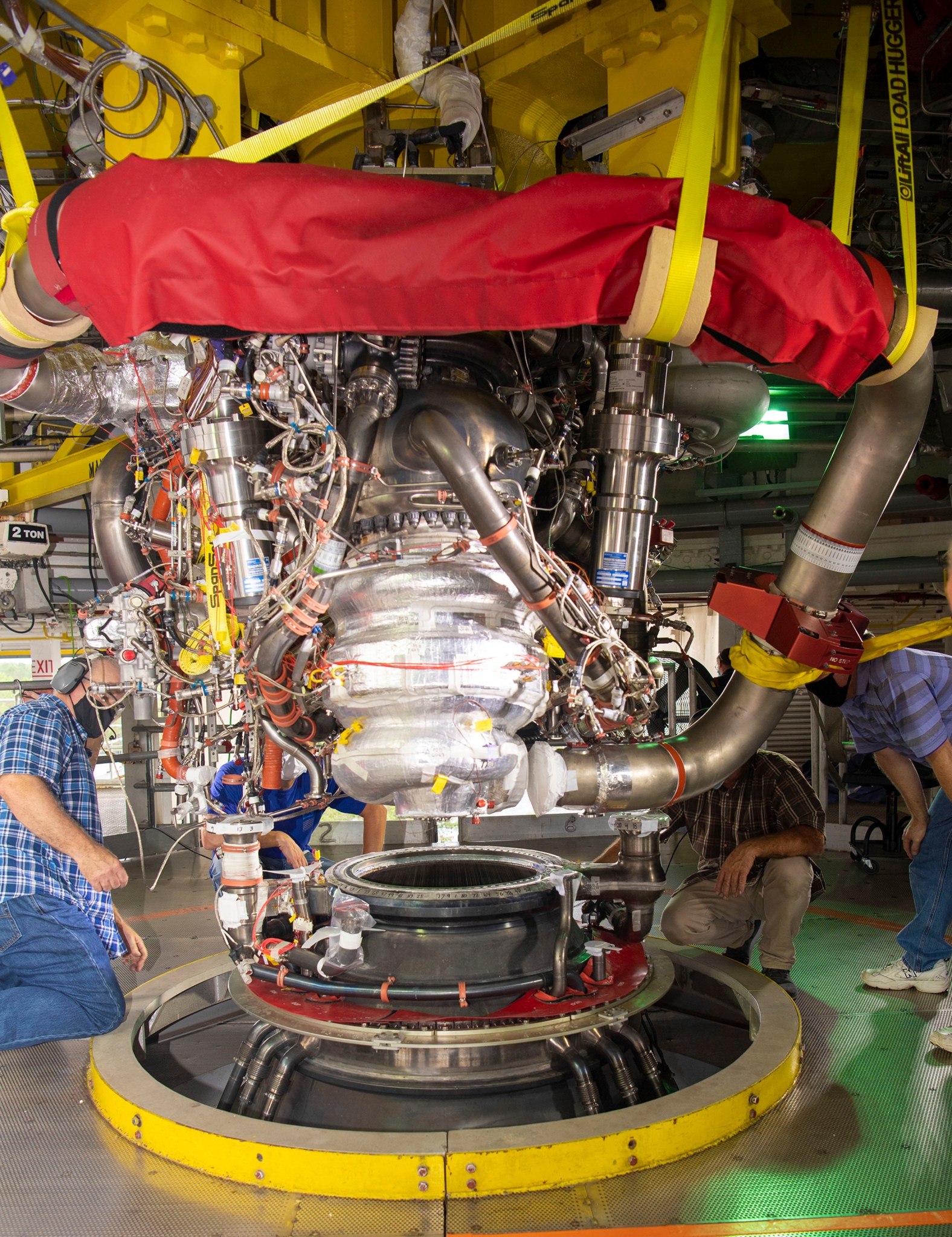 Technicians on the engine deck of the Fred Haise Test Stand