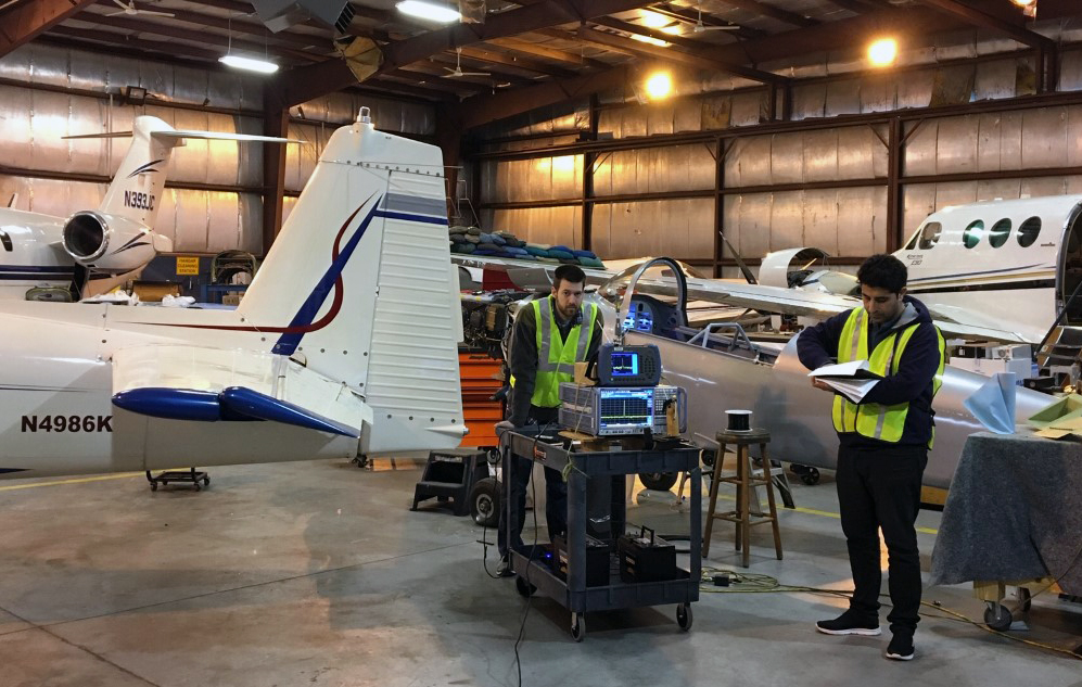 H. Students Ken McGill (left) and Nozhan Hosseini from the University of South Carolina conduct research inside an aircraft maintenance hangar in support of NASA’s aeronautics research goals through the agency’s University Leadership Initiative.