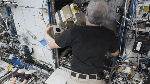 moving image of astronaut working on an experiment