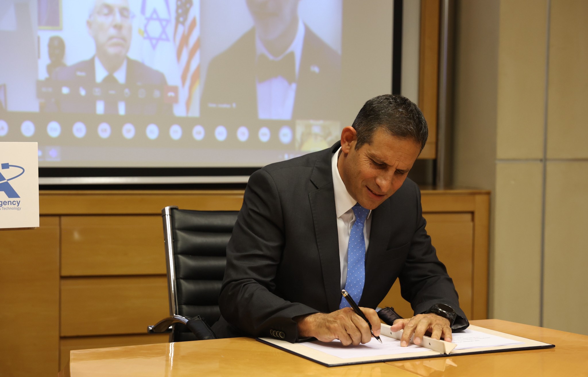 Israel Space Agency Director General Uri Oron signs the Artemis Accords during a ceremony in Tel Aviv Jan. 26, 2022.